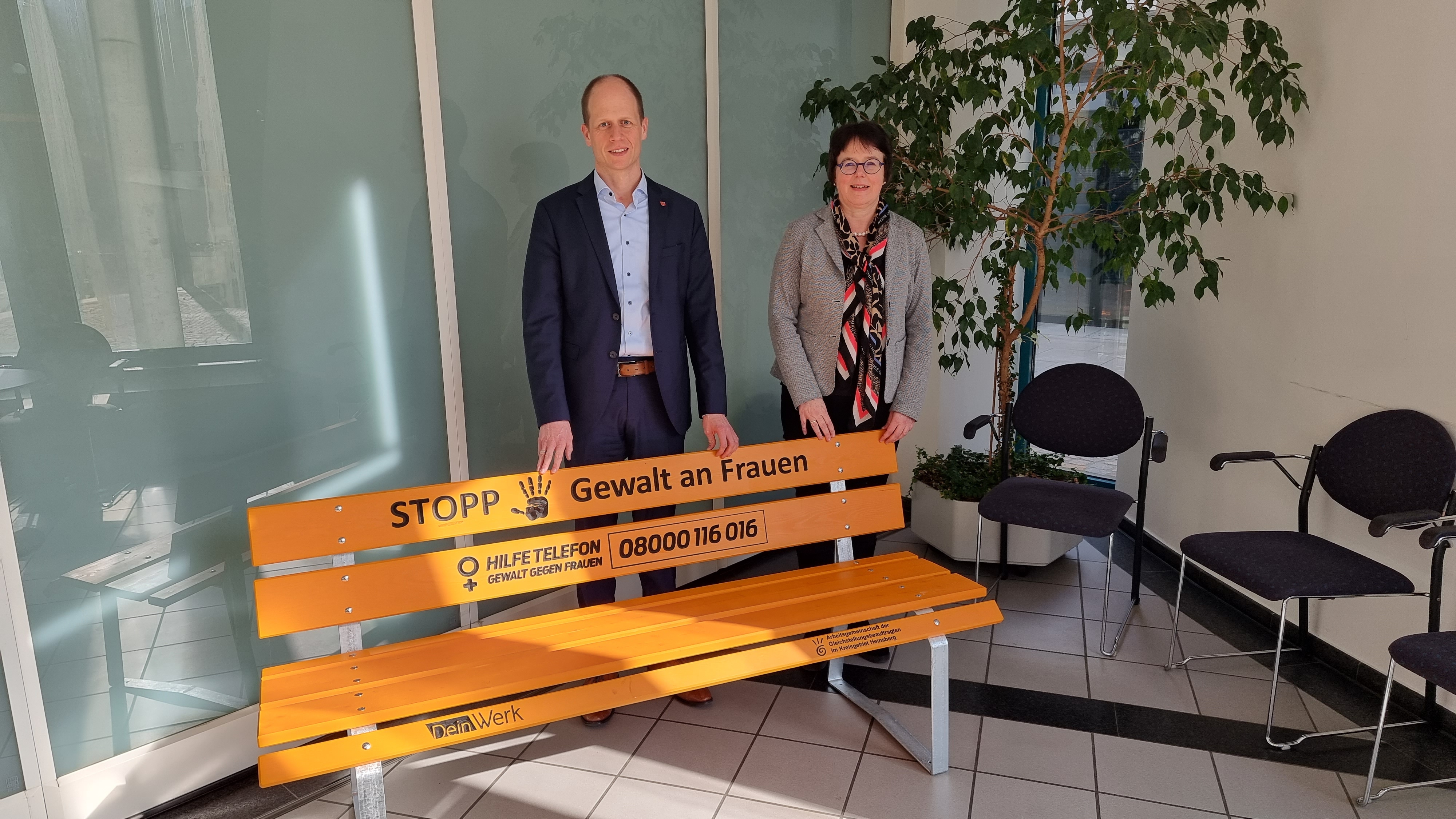 Bürgermeister Kai Louis und Gleichstellungsbeauftragte Marika Schroeder hinter der Bank Stoppt Gewalt an Frauen