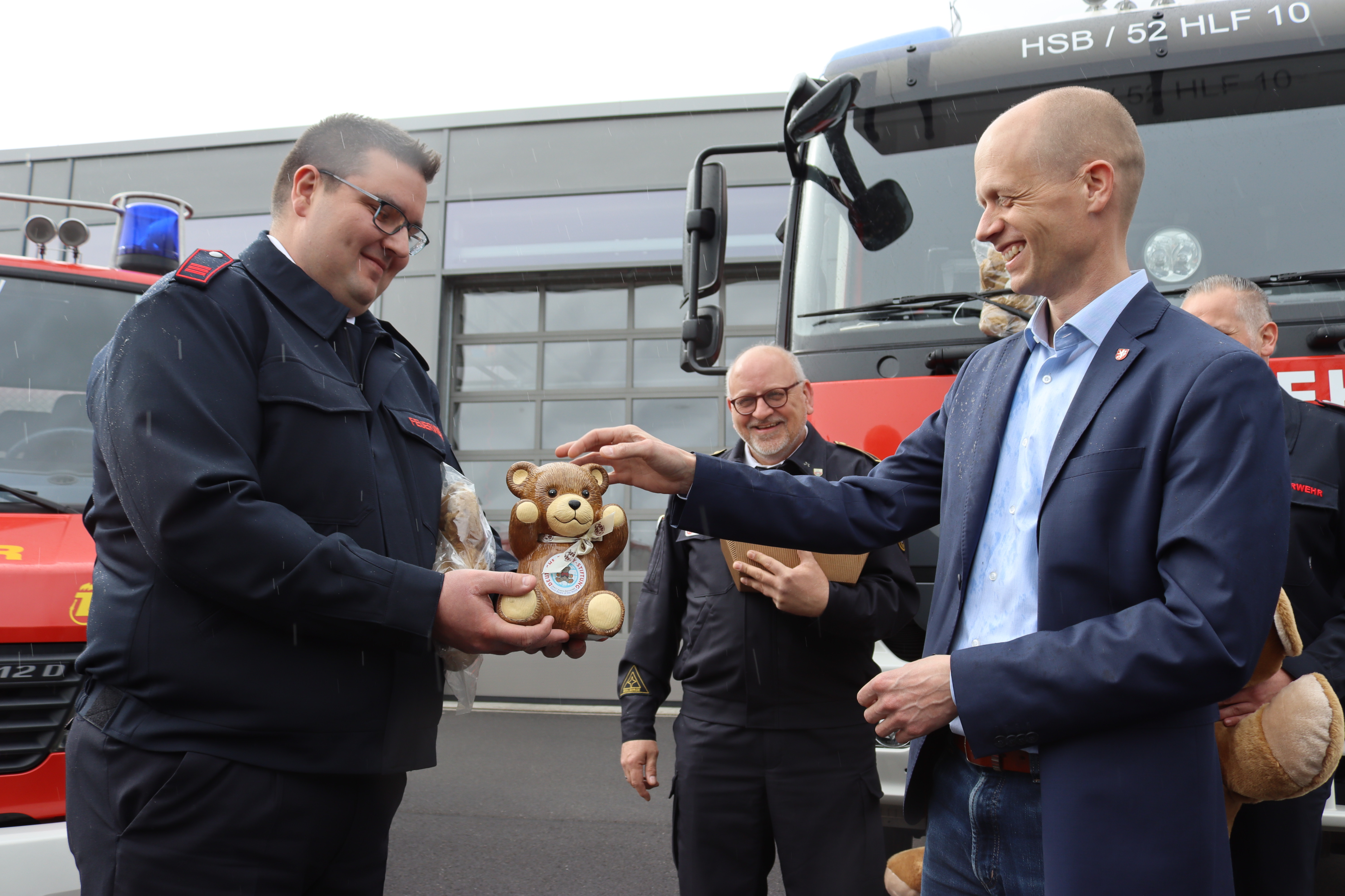 Tobias Holter, Helfer Psychosoziale Notfallversorgung, überreicht Bürgermeister Kai Louis einen „Tröstebären“